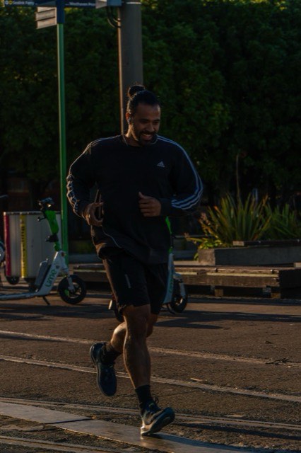 A runner training under the city lights