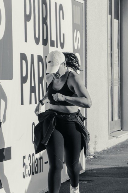 A runner pausing beside the waterfront after a session