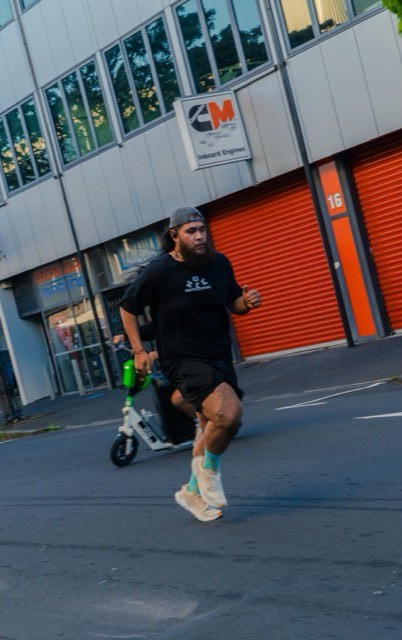 A runner moving past the marina at night