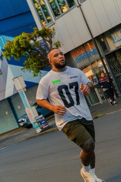 A runner wearing an NTIB training shirt in the city